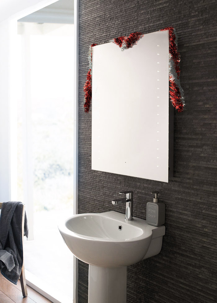 bluetooth mirror Christmas bathroom with tinsel 