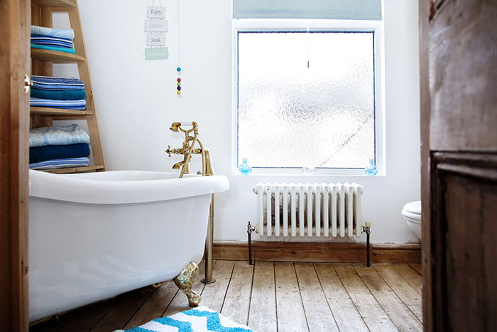 Traditional freestanding bathtub in a small, neural design bathroom