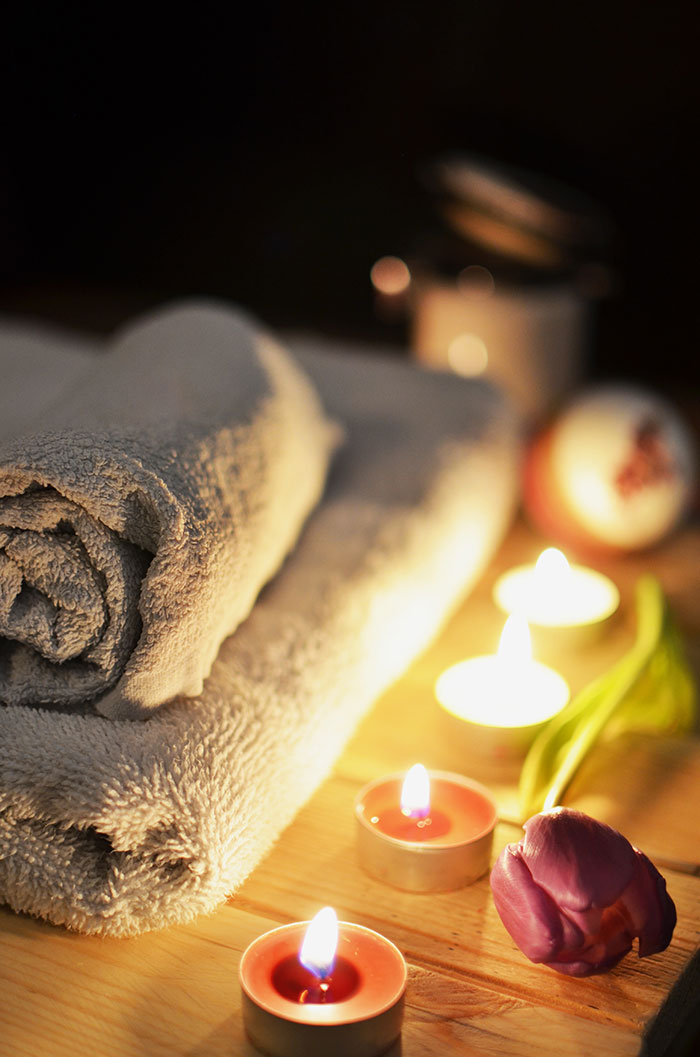 Candles, towels, and a flower