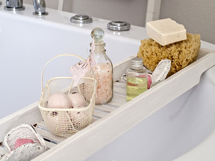 Bathtub rack with bath bombs, salts, and sponges