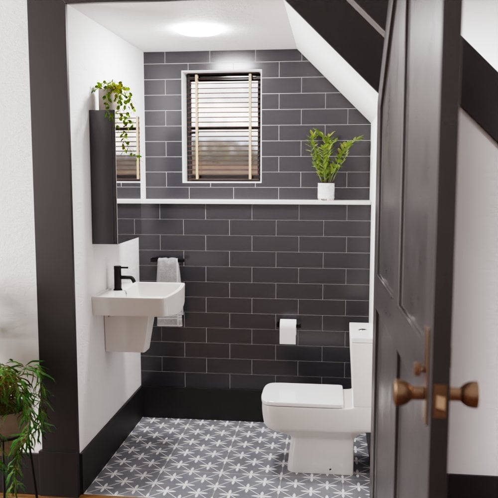 Modern tiled cloakroom bathroom with metro tiles, greenery, toilet and semi pedestal basin.