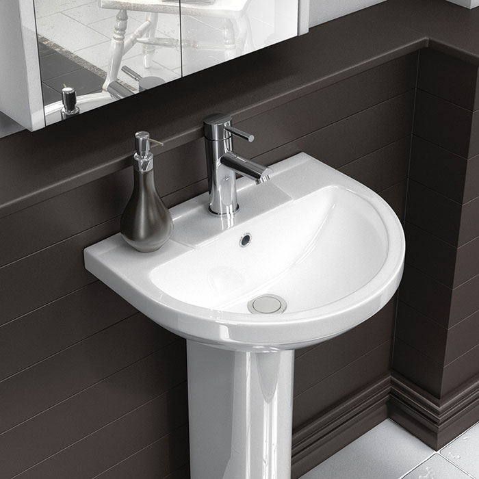 White pedestal basin with chrome basin tap, overflow and waste