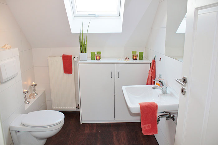 White bathroom with orange accessories 