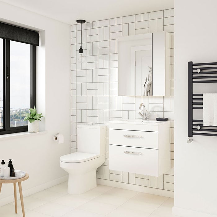 Minimalist bathroom with white subway tiles and wall hung furniture 