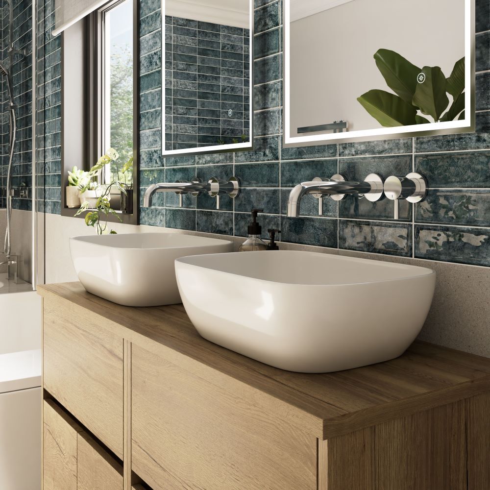 Double bathroom sinks on wood vanity with blue tile splashback