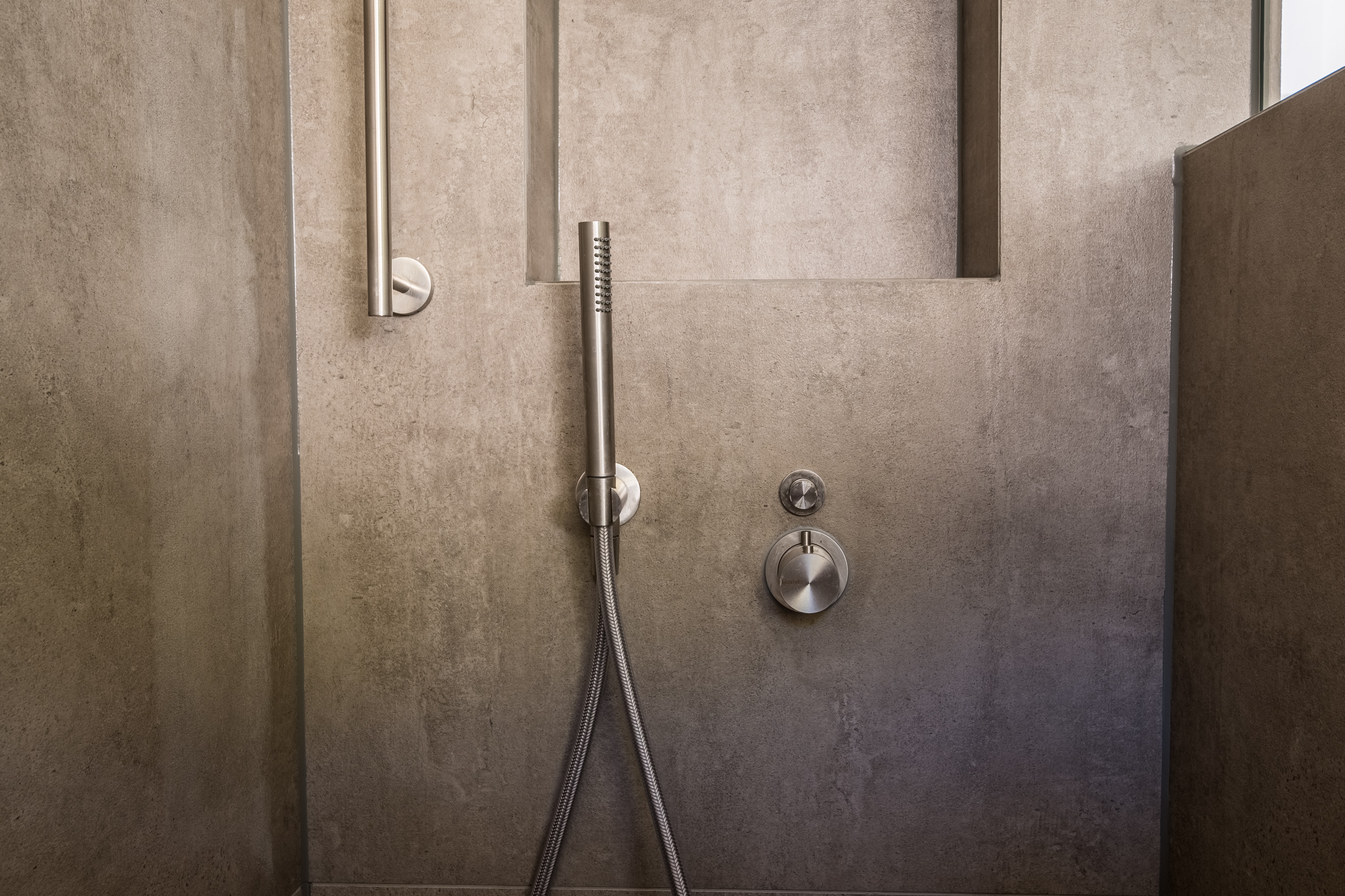 Concrete effect shower wall in an industrial style bathroom