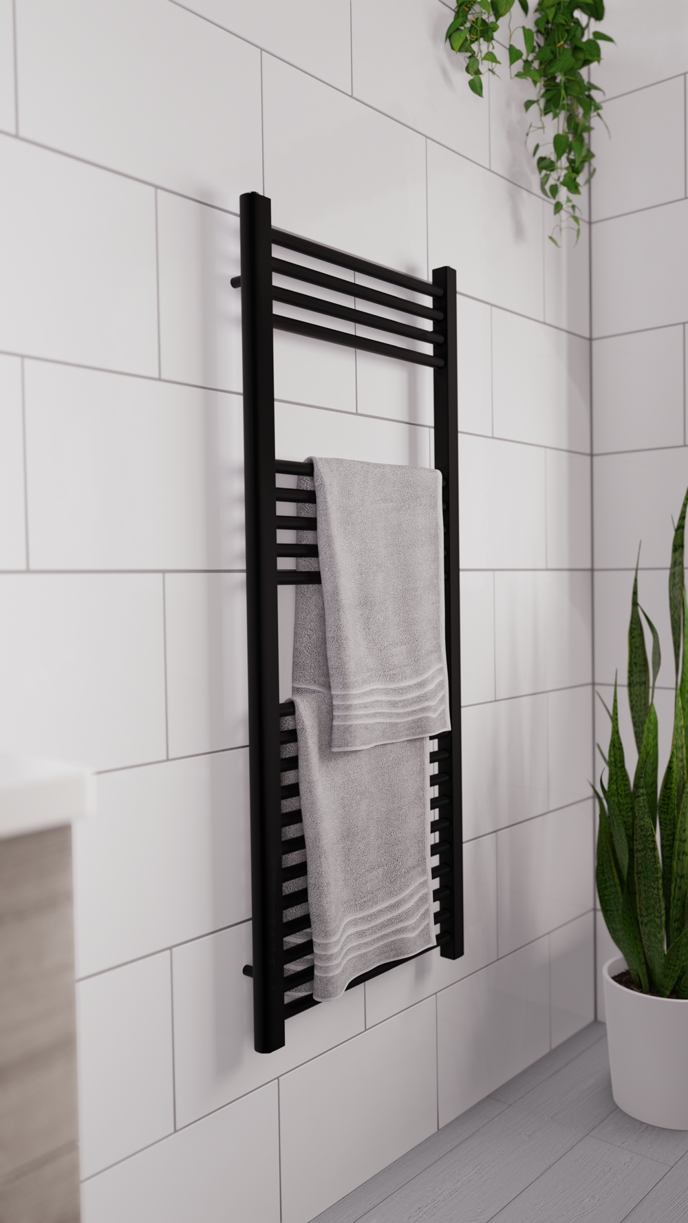 Black heated towel rail with towel hanging on it