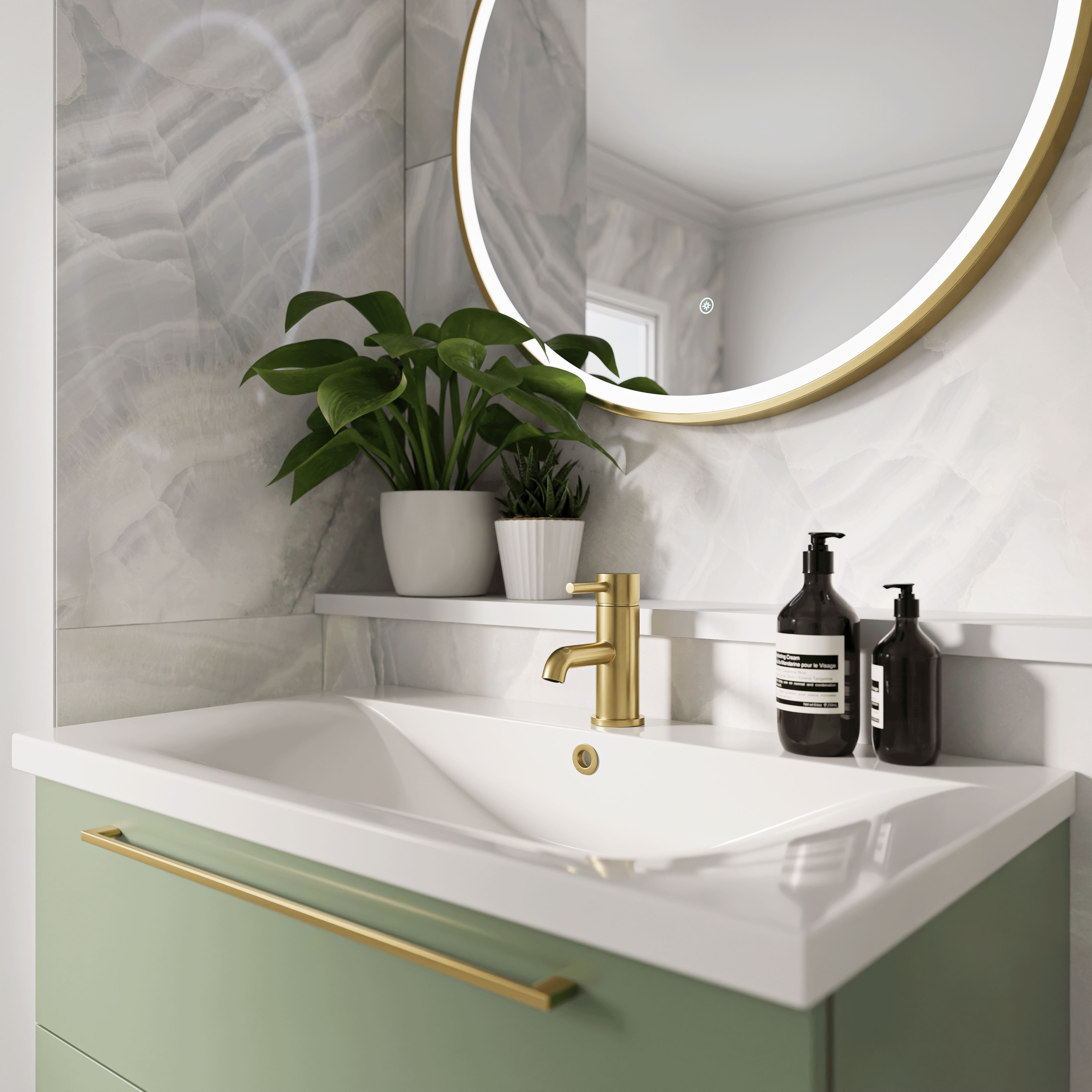 bathroom sink unit with brass tap and greenery