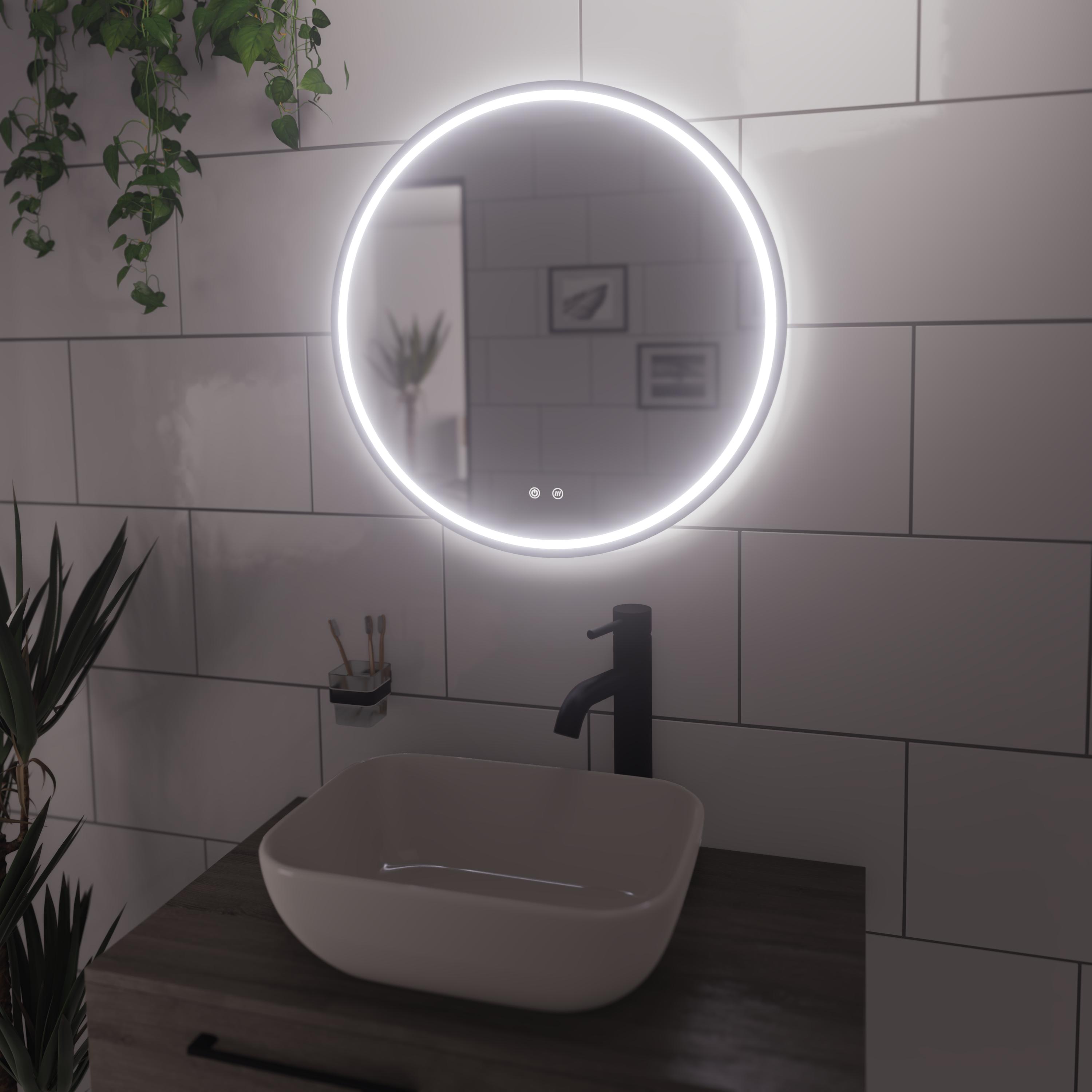 Illuminated mirror above a countertop basin and vanity unit